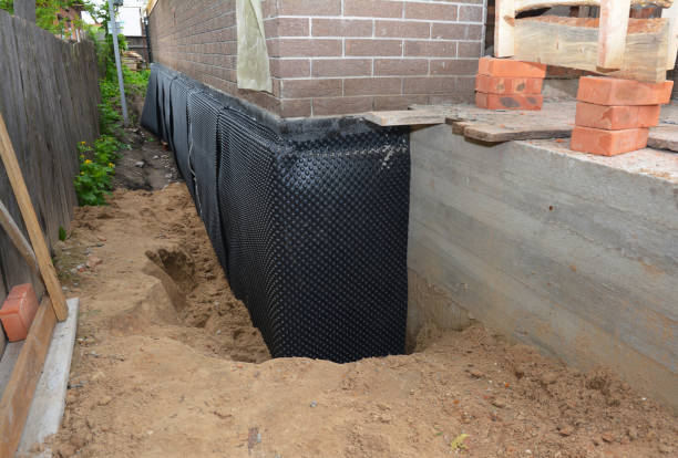 Happy homeowners after waterproofing job in Lacota